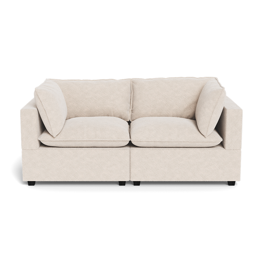 The Kova Pillow Cushion Sofa 86" is a beige two-seater with square cushions and armrests on both sides, shown against a white background.