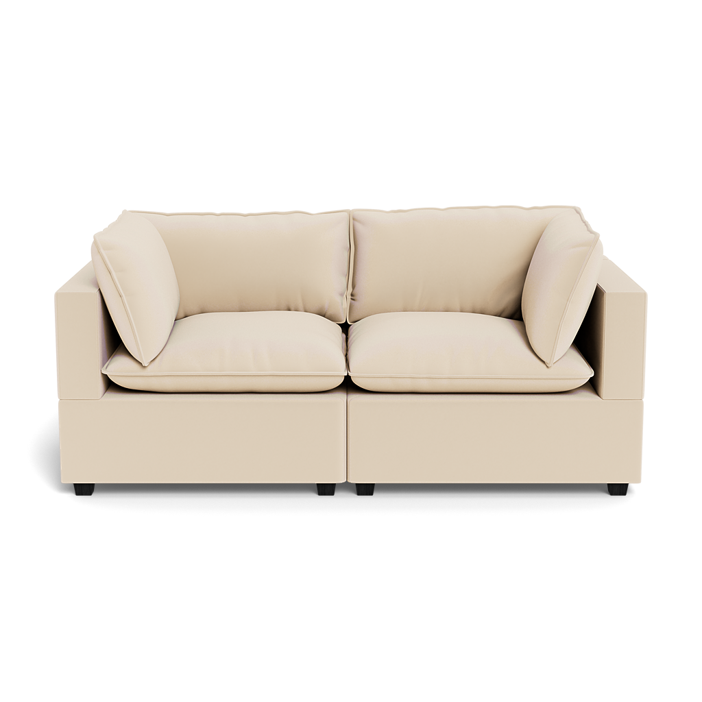The Kova Pillow Cushion Sofa 86" is a modern beige two-seater with plush seat and back cushions, plus two matching side pillows, shown from the front against a plain background.