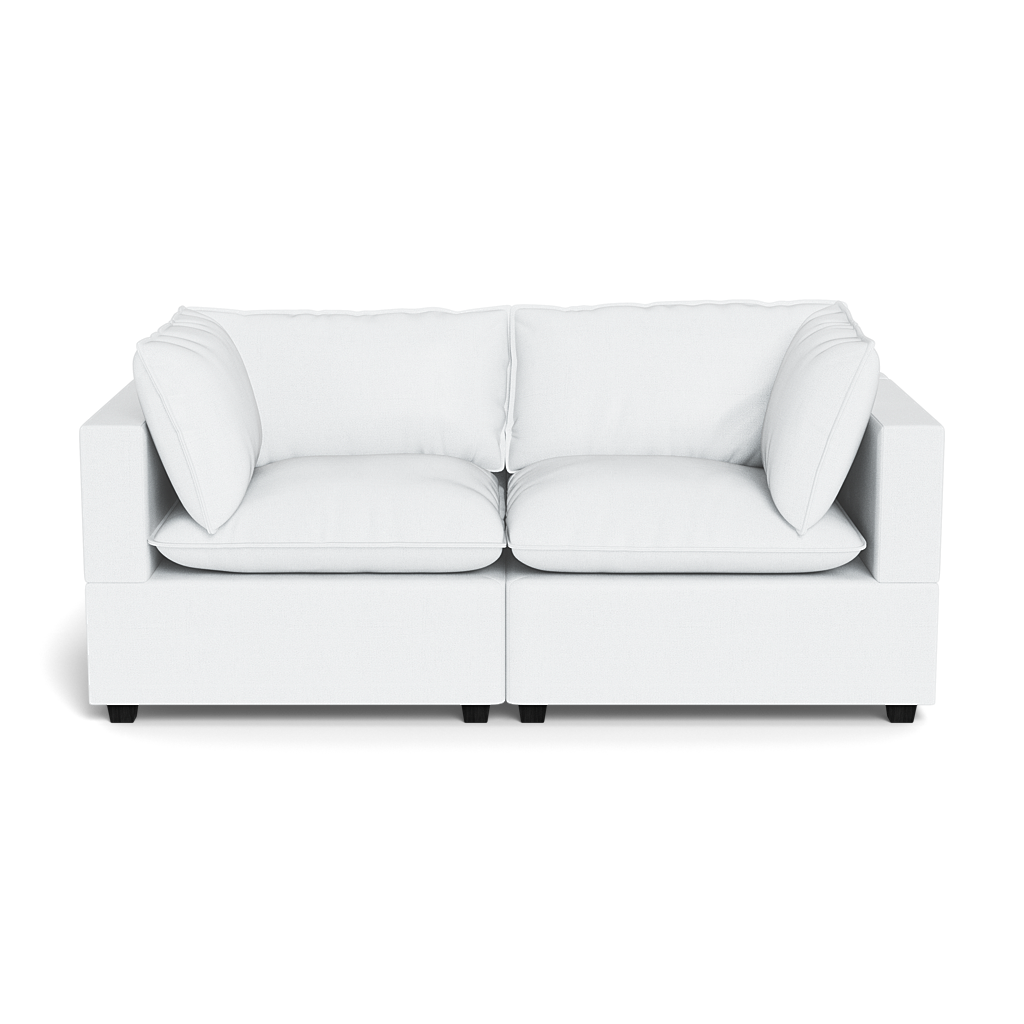 The Kova Pillow Cushion Sofa 86" is a modern white two-seater with square arms and plush cushions, shown against a plain black background.