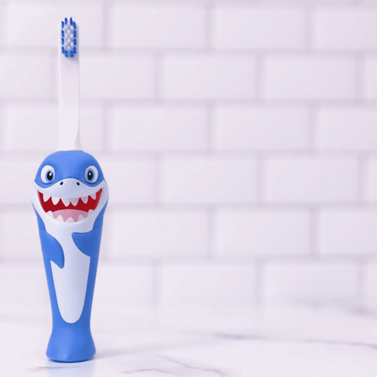 Blue shark toothbrush for kids with soft bristles and playful design for easy brushing